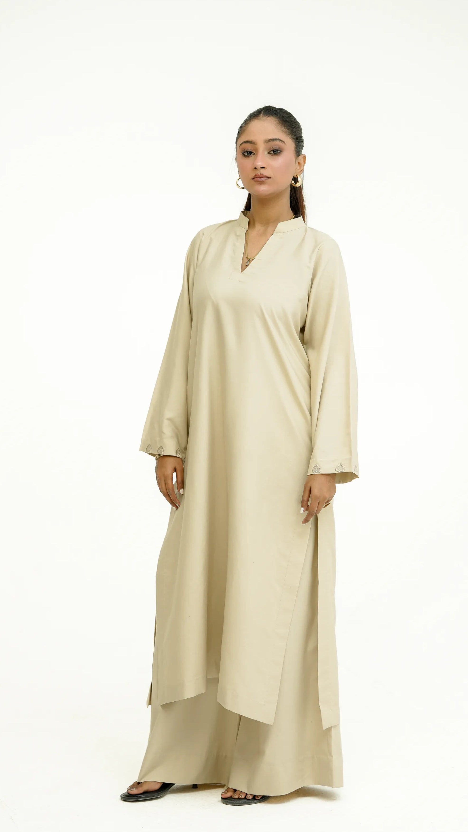 Woman wearing ivory “Afsaana | افسانہ” eastern outfit